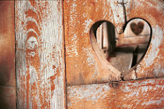 Photo of a heart cut out of a wooden fence