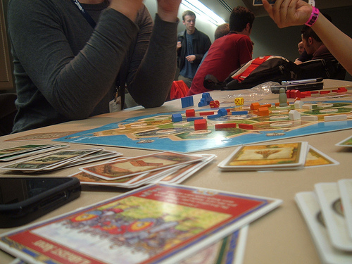 Photo of gamers playing Settlers of Catan, photo by sewing puzzle via Flickr