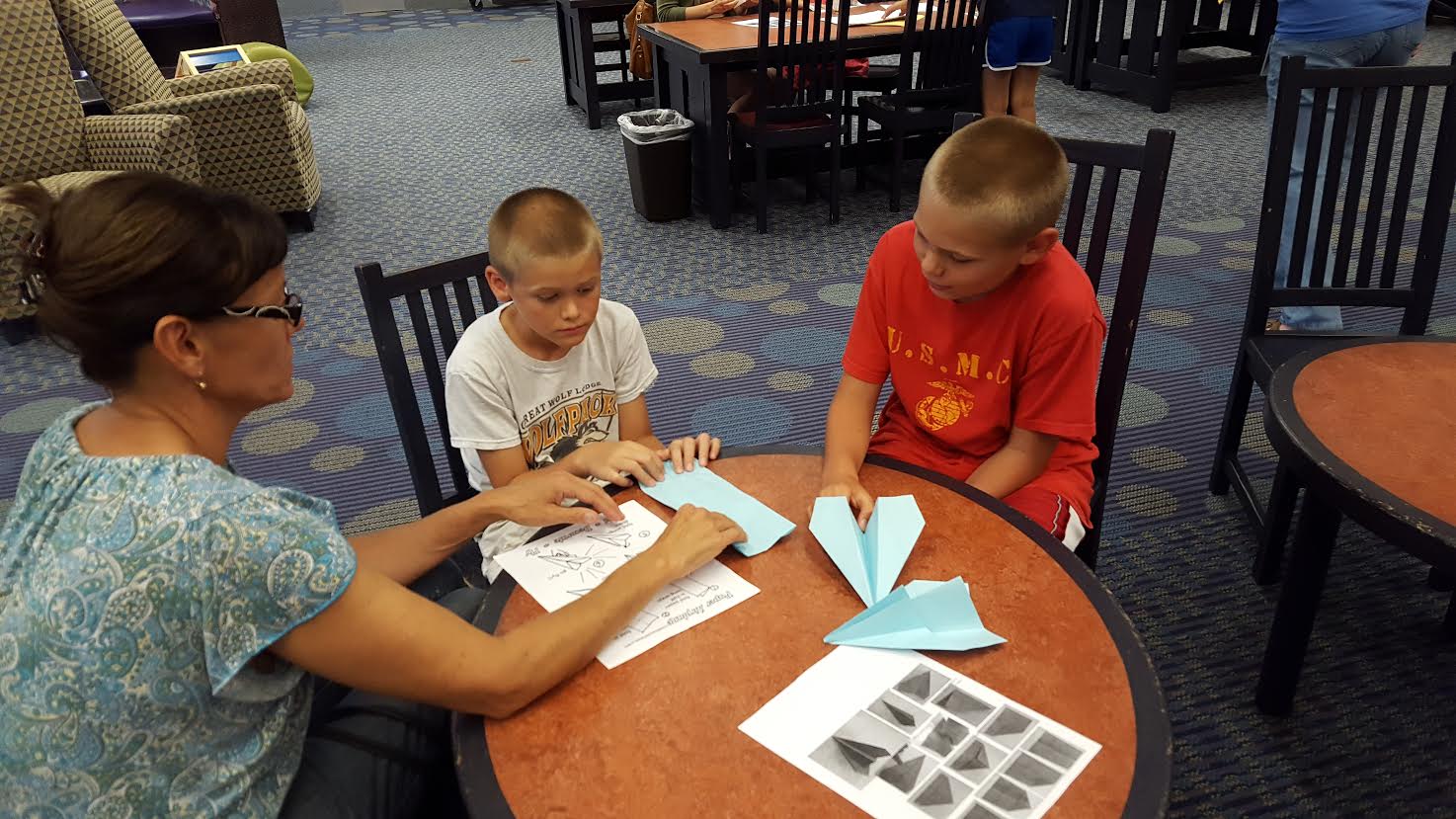 Kids making paper airplanes