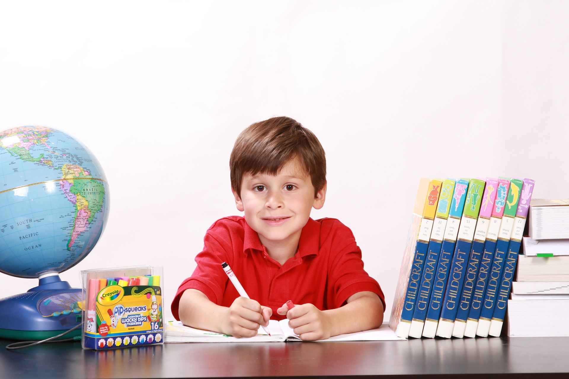 Photo of boy coloring with markers