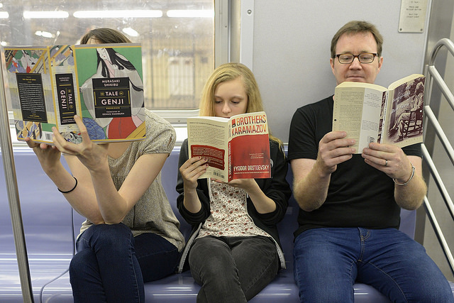 photo of people reading on the subway