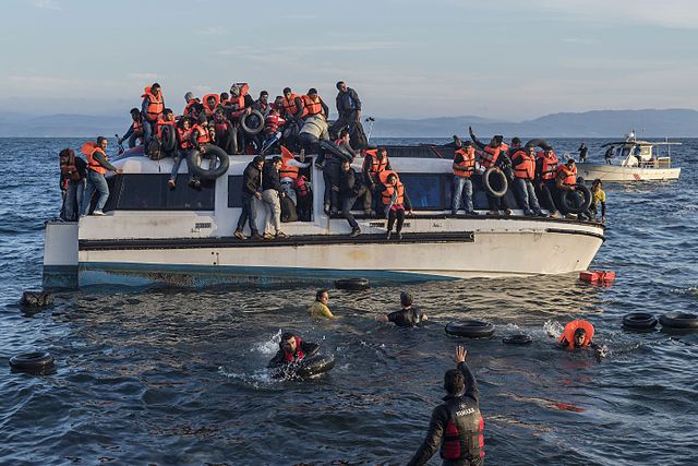 photo of refugees arrive in Greece via life boat