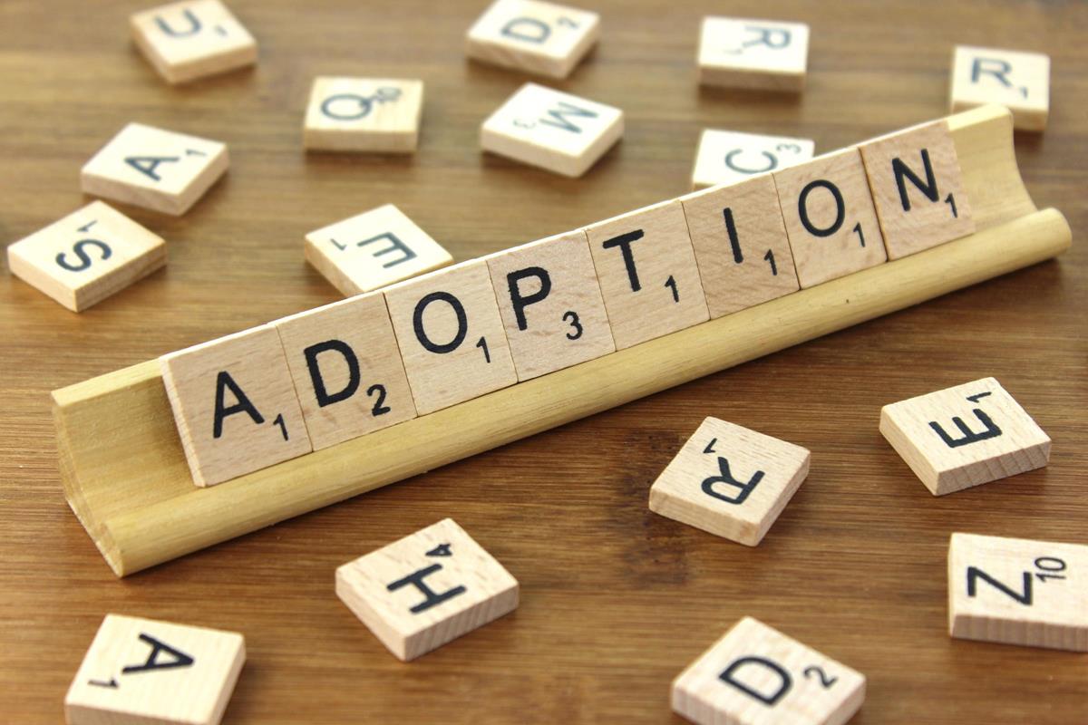 Adoption spelled with Scrabble tiles