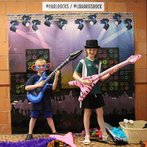 kids pose with rock 'n' roll props