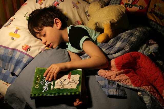 child reading in bed