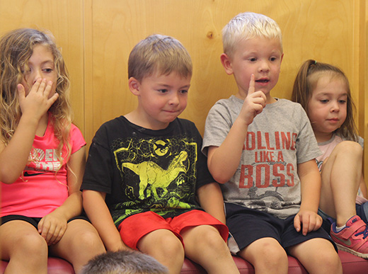 children participating in story time at a local child care center