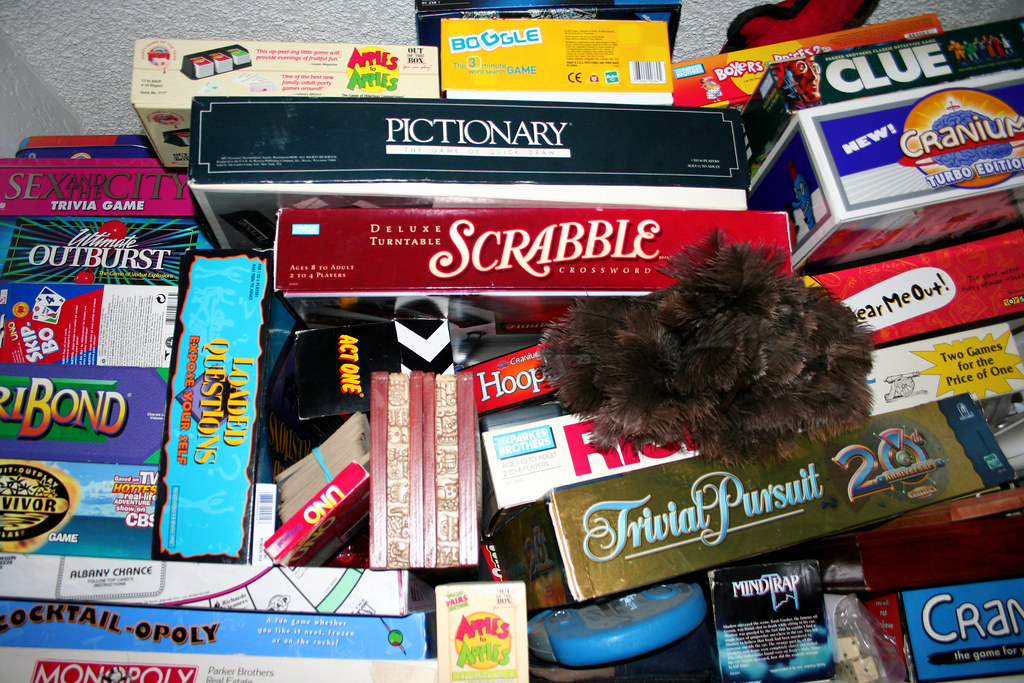 stack of board games in a closet