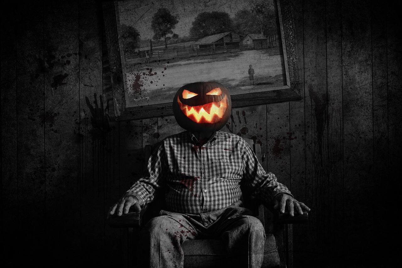 scary image of man with jack'o lantern head in dark room