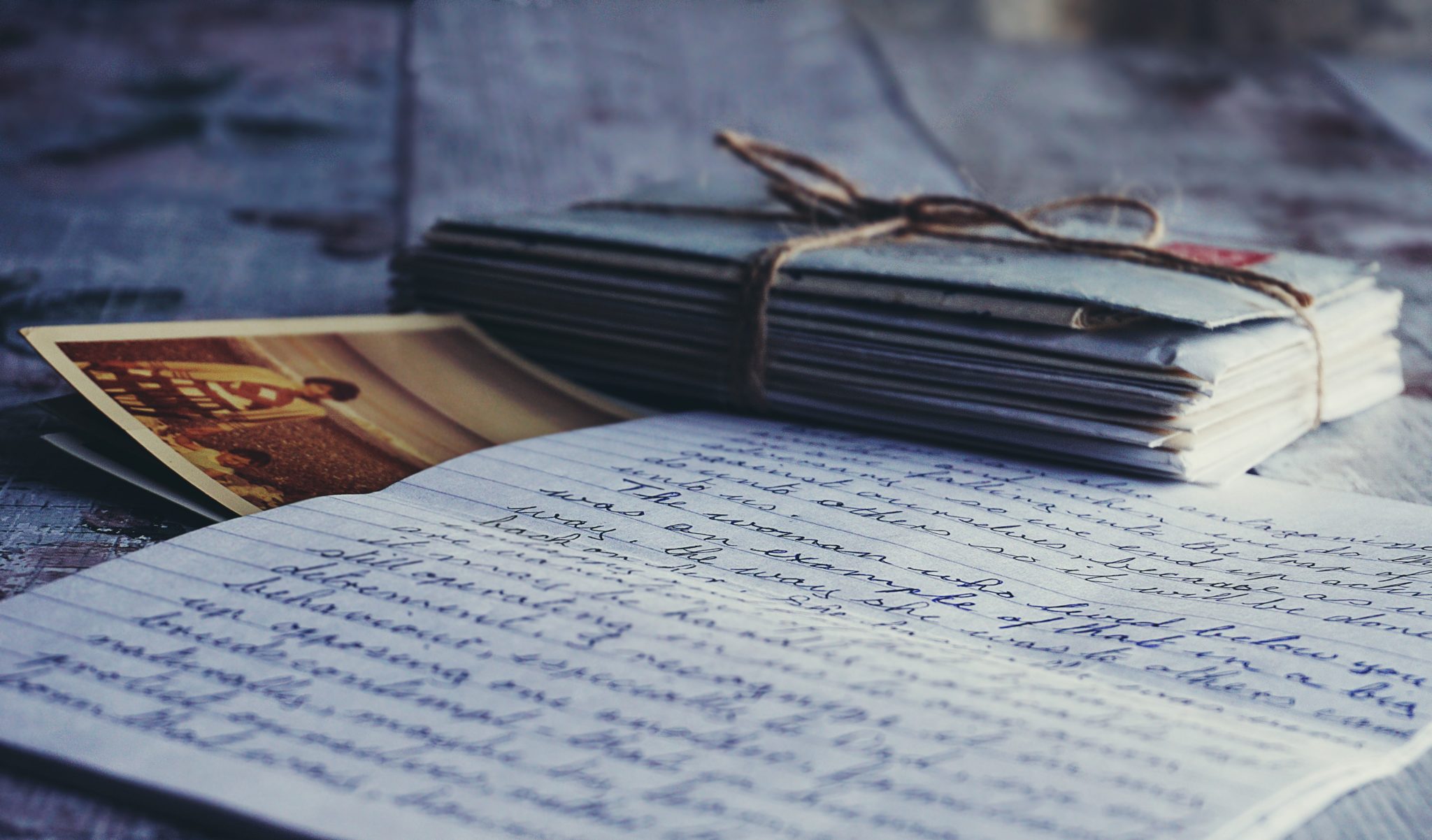 photo of letter with a stack of envelopes and photos