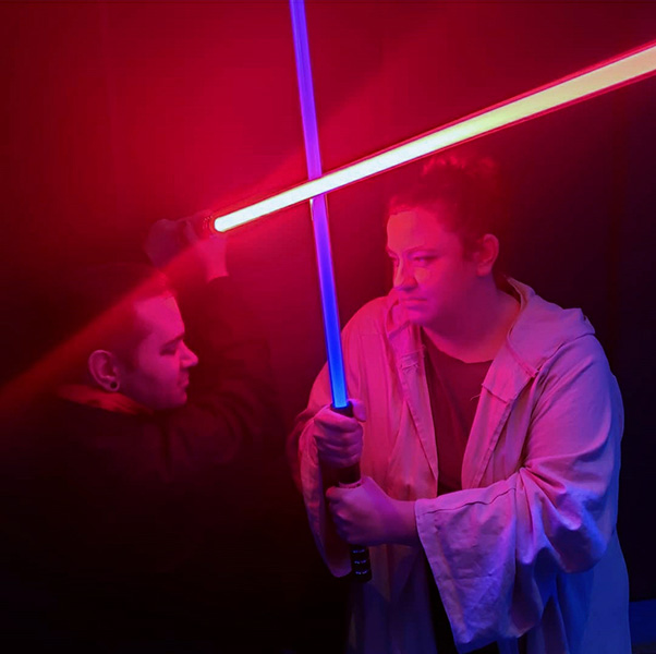 Two people dueling with lightsabers.