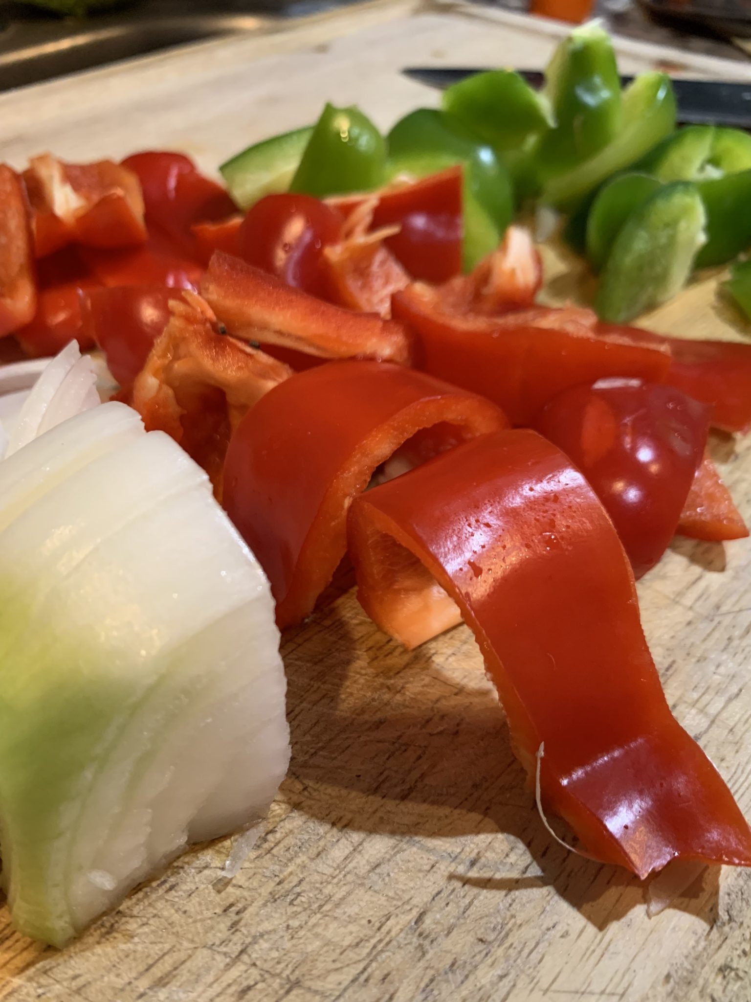 Picture of chopped onions, red peppers and green peppers.