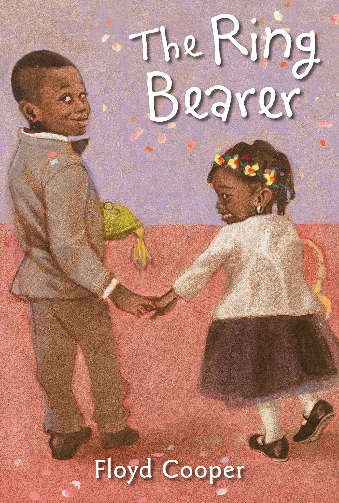 The cover of the book "The Ring Bearer" features two Black children walking down the aisle at a wedding. The boy on the left is the ring bearer and looks back at the viewer with a smile, while the girl on the right is the flower girl and looks back with an anxious expression. 