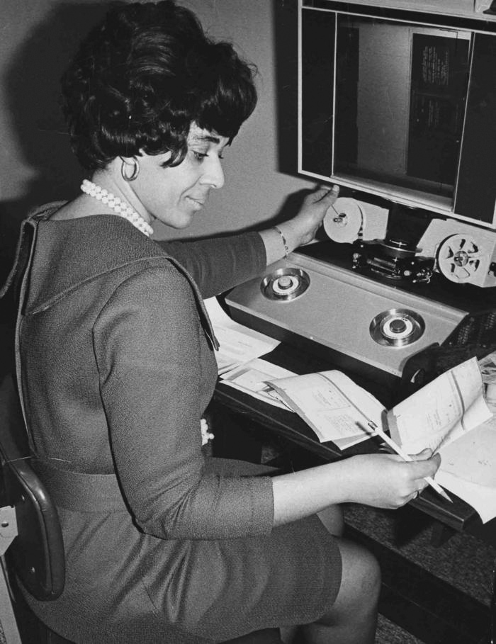 Circulation staff, working with circulation records stored on microfilm at the old 100 W. Broadway library building, 1973