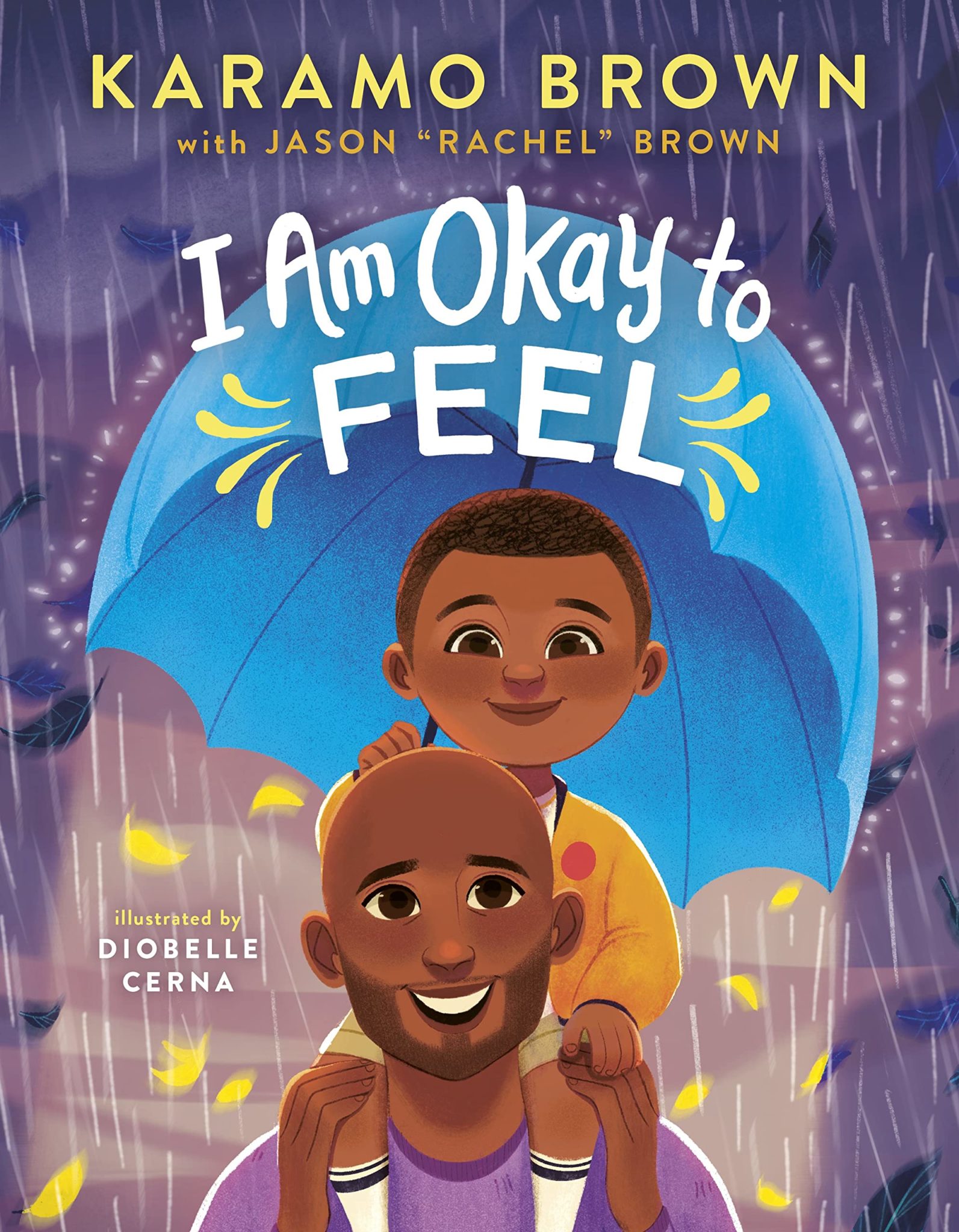 The cover of the picture book "I Am Okay to Feel" features a boy sitting on his smiling dad's shoulders. The boy holds an umbrella to protect them from a rainstorm.