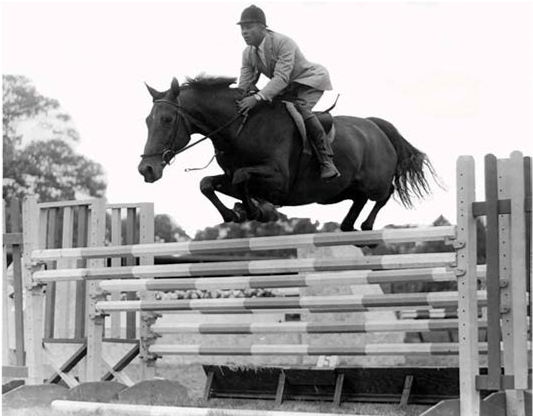 image of Chalres "Sonny" Brooks, a Black man riding on a horse as it jumps