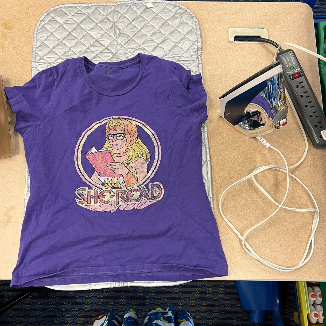 Photo of a t-shirt next to an iron