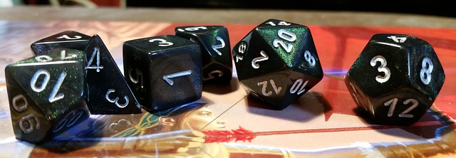 A group of seven role-playing game dice arranged on a play mat.