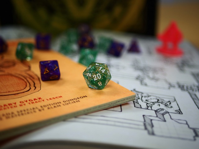 A collection of role-playing game dice strewn across a game book and a grid map. 