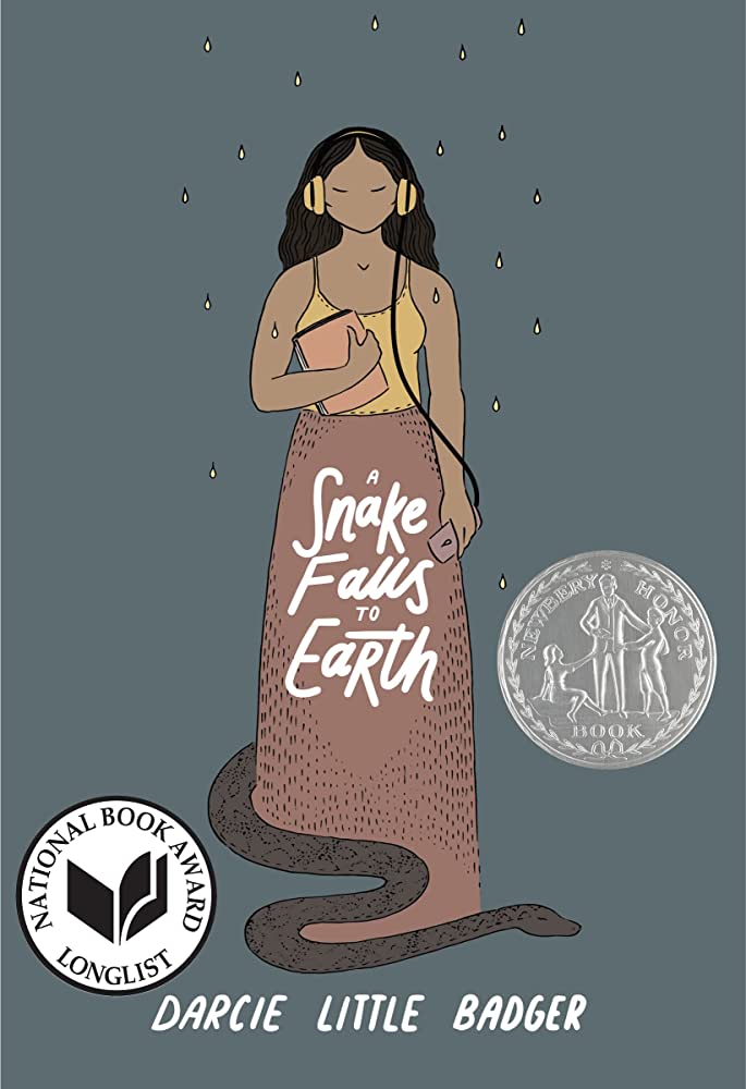 Cover of Darcie Little Badger's YA novel "A Snake Falls to Earth," featuring a brown-skinned Indigenous girl with wavy black hair wearing yellow over-the-ear headphones, a yellow tank top and a long mauve skirt. At the bottom of the girl's skirt, a dark gray snake slithers out. Yellow rain drops fall from the top of the image across the girl and the snake. 