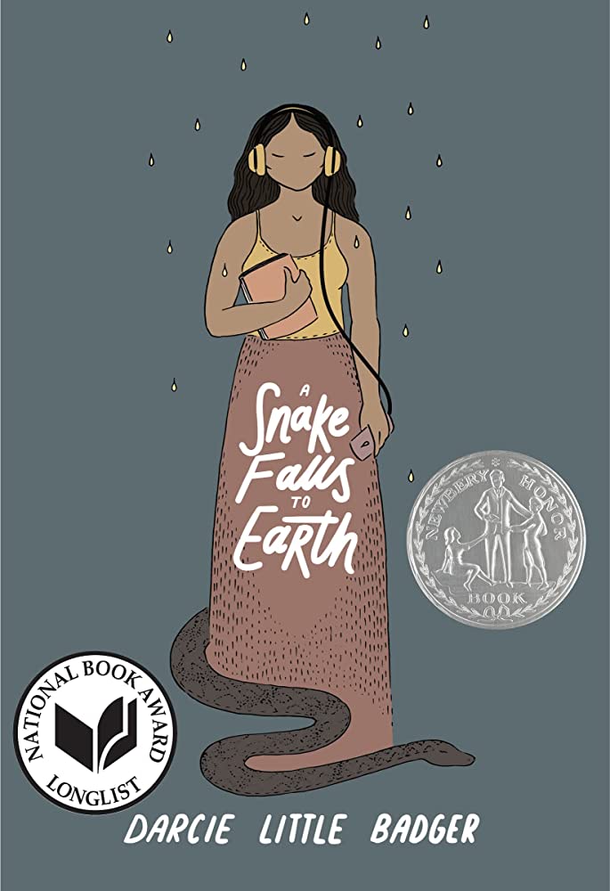 Cover of Darcie Little Badger's YA novel "A Snake Falls to Earth," featuring a brown-skinned Indigenous girl with wavy black hair wearing yellow over-the-ear headphones, a yellow tank top and a long mauve skirt. At the bottom of the girl's skirt, a dark gray snake slithers out. Yellow rain drops fall from the top of the image across the girl and the snake.