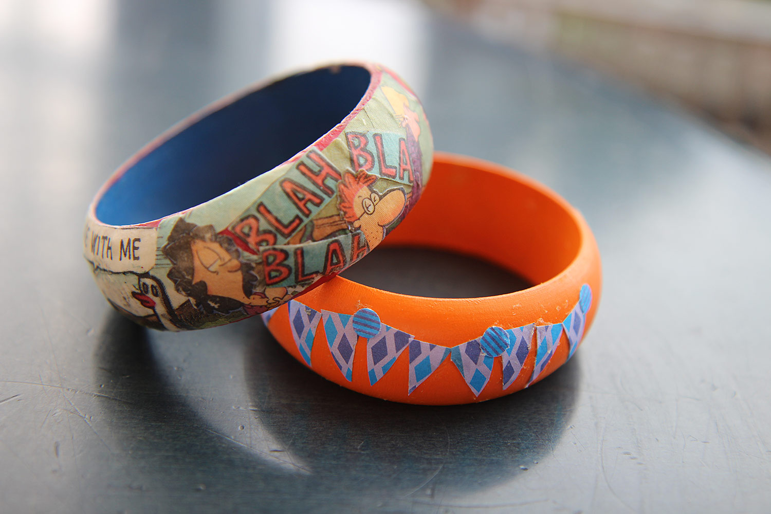 wooden bangles with decorative paper adhered to it