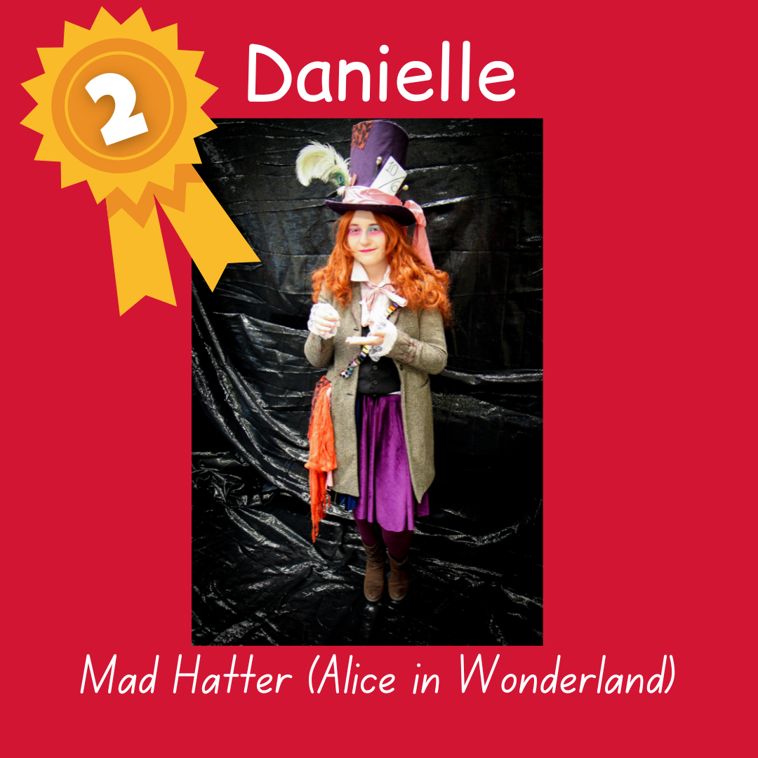 2nd place Danielle as Mad Hatter from Alice in Wonderland. Photo of an adult with an ornate purple top hat, red hair, tweed jacket and purple skirt.