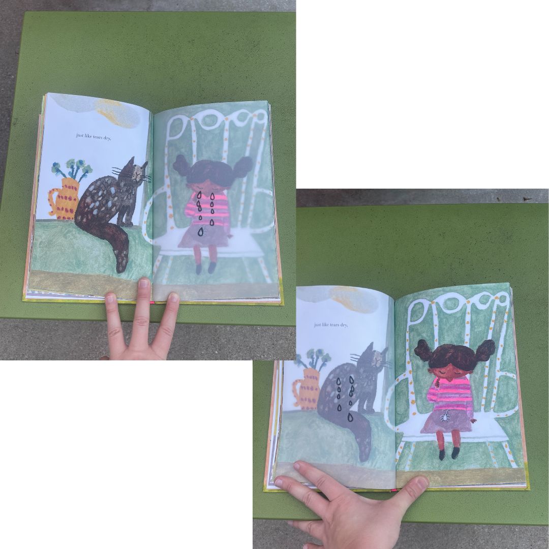 Two images showcasing interactive details and design choices from the picture book "Things That Go Away" by Beatrice Alemagna. In the first image, the book is held open by a white hand on a green stool: on the two pages of the book a brown cat with mottled fur sits on a green bed (the left page) while a young brown-skinned child cries on a big white chair (the right page). The child's tears are printed on a transparent page between the cat and child illustrations. When the transparent page is flipped (as demonstrated in the second image), the child's tears disappear/transform into speckles in the cat's mottled fur. 