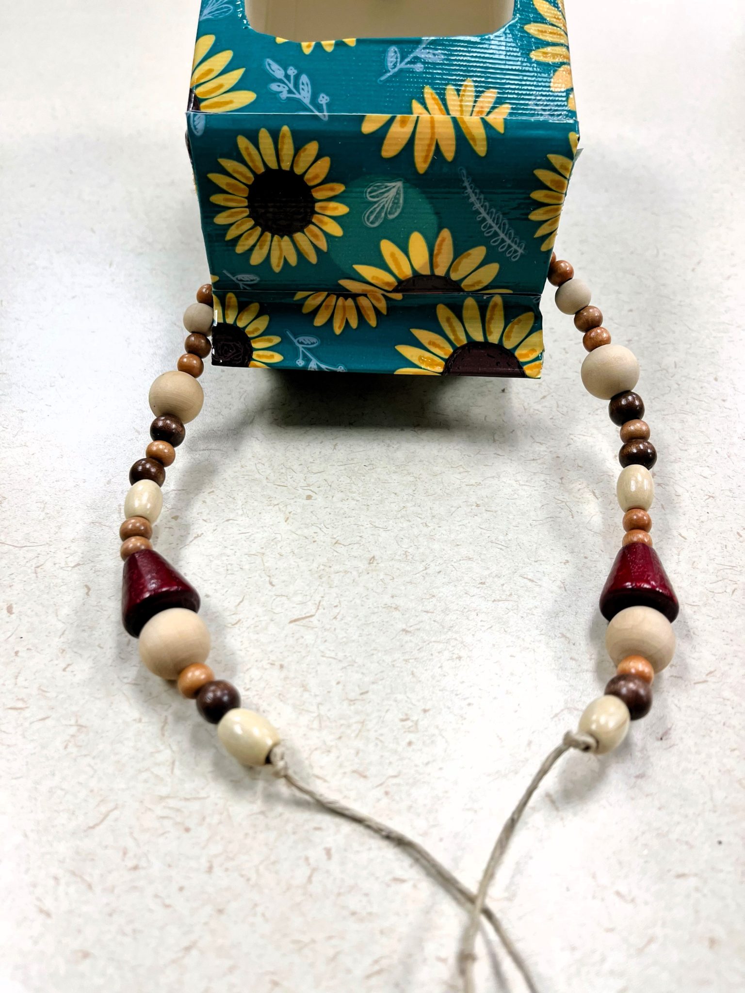 Bird feeder with string of beads added to hang