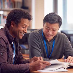 Two adults reading together