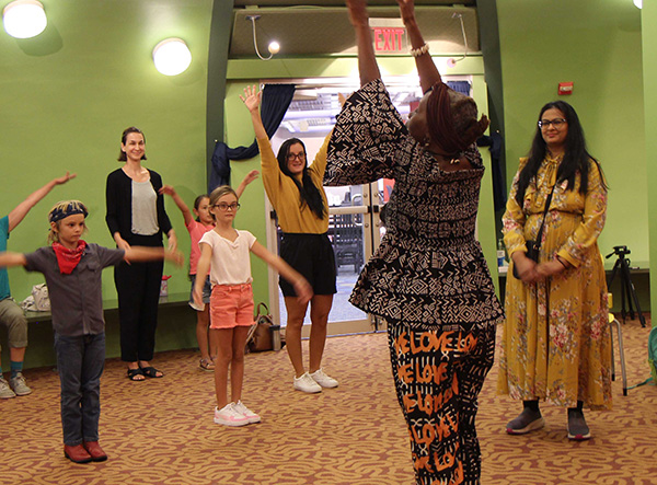 People of all ages enjoying a multicultural dance event.