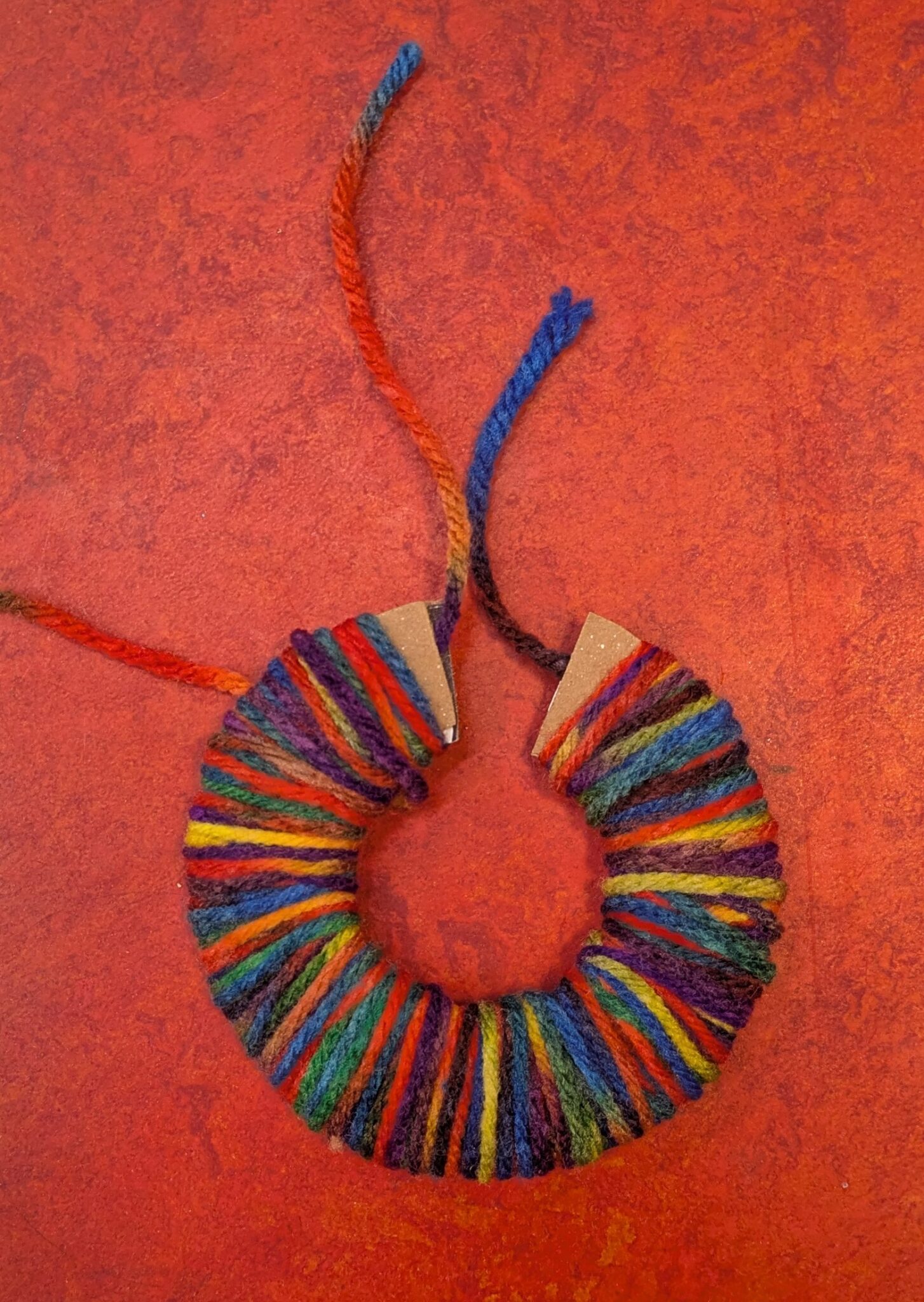 Yarn wrapped around cardboard 'c'