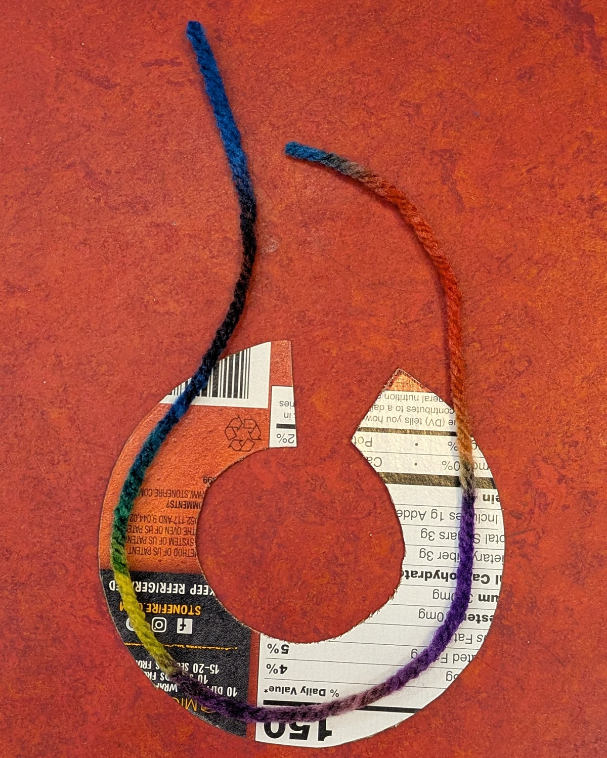 String on cardboard 'c'