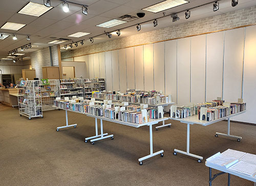 Tables of books inside the Callaway County Public Library temporary location 