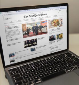 Laptop showing the digital version of the New York Times