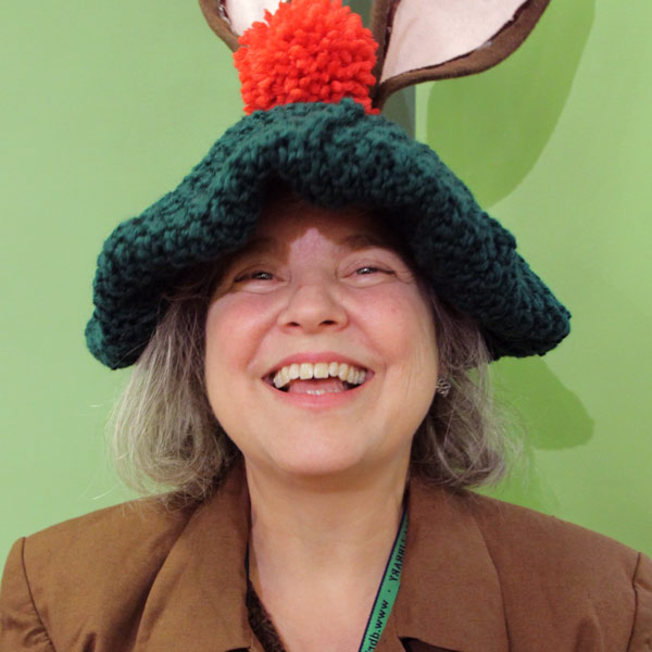 Aimée Leonhard smiling and wearing a silly hat